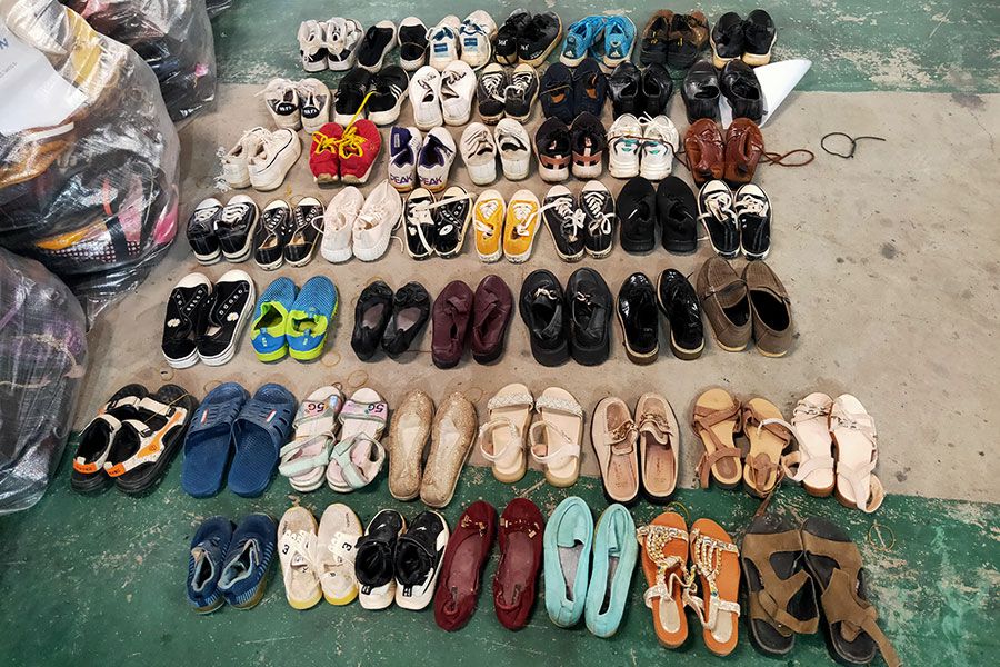 several rows of used shoes and slippers that each bale contains